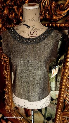 "This sparkling top is from the 50's by RS Boutique NY. Made of a gold lamé with braided detail neckline and gold beads.  Fully lined.  Zips up the back with a metal zipper.  Excellent condition. Best fit would be a Medium, however, please see the measurements below for a proper fit.  All sales are final. Measurements Armpit-armpit doubled 38\" Waist 34\" Length 19\"" Vintage Gold Top For Formal Occasions, Formal Embellished Gold Tops, Glamorous Gold Formal Tops, Gold Fitted Top For Evening, Fitted Gold Top For Evening, Elegant Gold Embellished Top, Chic Embellished Gold Tops, Elegant Fitted Gold Top, Vintage Gold Tops For Night Out