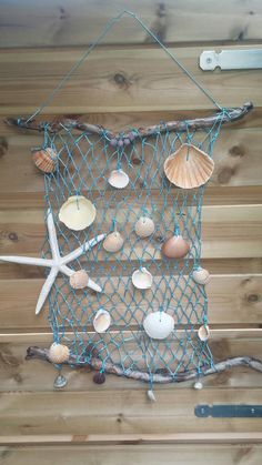 there is a net with shells and starfishs hanging on the wall next to it