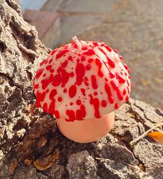 a red and white mushroom sitting on top of a tree