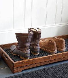 two pairs of boots are sitting on a tray