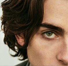 a man with freckles on his hair and green eyes