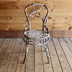 an old chair sitting on top of a wooden floor