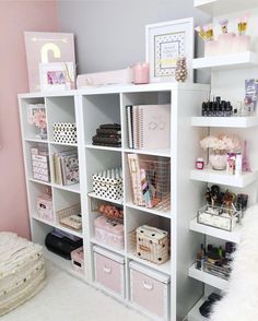 a white shelf filled with lots of pink and white items