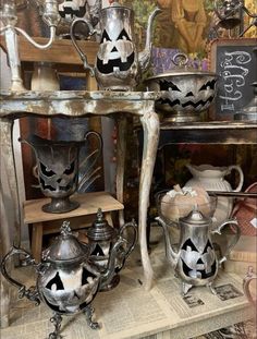 an assortment of antique teapots with jack - o'- lanterns painted on them