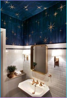 a bathroom with stars painted on the ceiling and white tile walls, along with a gold framed mirror