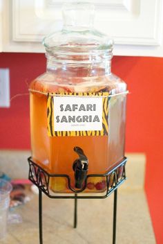 a jar filled with liquid sitting on top of a metal rack