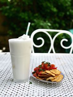 a plate of chips and a drink on a table