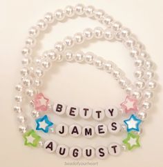 three bracelets with words and stars on them that say betty, james, august