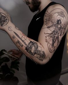 a man with many tattoos on his arm