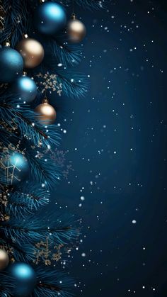 a blue christmas tree with ornaments and snow flakes on it's branches in front of a dark background