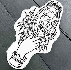 a sticker with a skull holding a mirror and flowers on it's arm