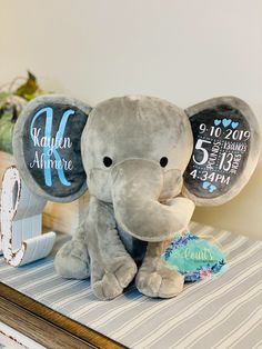 an elephant stuffed animal sitting on top of a table