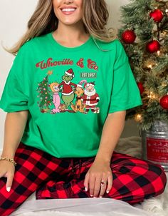 GRINCHMAS WHOVILLE SHIRT - "Whoville Est 1957" Tee Celebrate the spirit of Whoville with our "Whoville Est 1957" shirt! Perfect for holiday festivities or as a unique Christmas gift, this tee adds a touch of Whoville charm to your wardrobe. Whether you're a fan of the Grinch or just love festive fun, this shirt is a delightful choice. Product Features: Material: Made from 100% cotton for a soft, comfortable feel. Sport Grey features 90% cotton and 10% polyester, Ash Grey includes 99% cotton and 1% polyester, and Heather colors are a 50/50 blend of cotton and polyester. Fabric Weight: 5.0-5.3 oz/yd² (170-180 g/m offering a substantial yet breathable fabric. Fit: The unisex classic fit provides a structured look, ideal for layering or wearing solo. Construction: Features open-end yarn, tubul Green Short Sleeve Christmas Tops, Green Short Sleeve Holiday Top, Whoville Shirt, Cindy Lou Who Shirt, Green Crew Neck Christmas Shirt, Cindy Lou Who Tshirt, Whoville University Sweatshirt, Der Grinch, Whoville Christmas