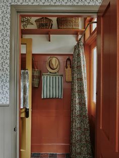 an open door leading to a bathroom with floral wallpaper