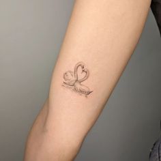 a small swan tattoo on the arm