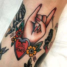 a woman's arm with tattoos on it and the word girl power written below