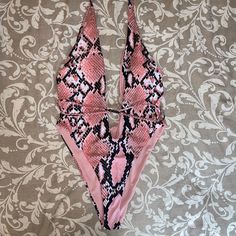 Shein Pink Snakeskin Pattern Strappy Adjustable Tie One Piece. Nwot Never Been Worn Trendy Pink One-piece Swimwear, Pink Stretch Bodysuit For Poolside, Pink Bodysuit For Beach Season With Lined Body, Pink Bodysuit With Lined Body For Beach Season, Pink One-piece Lined Bodysuit, Pink Lined Bodysuit For Swimming, Pink Lined Bodysuit For Beach Season, Pink Summer Bodysuit With Lined Body, Snake Skin