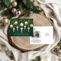 an image of christmas cards on top of a wooden slice with ornaments and pine cones