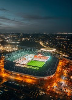 an aerial view of a tennis stadium at night