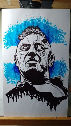 a drawing of a man's face with blue ink splatters on it