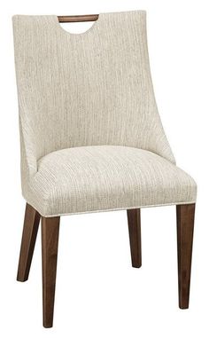 a white chair with wooden legs and a beige upholstered back rest on a white background