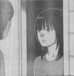 a girl looks at herself in the mirror while she stands next to an open window