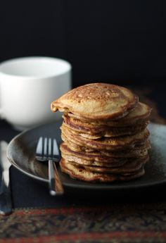 a stack of pancakes sitting on top of a black plate