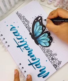 a person is writing on a notebook with butterflies and flowers in the background that says congratulations