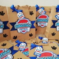 several brown bags with blue bows and mickey mouse tags on them are sitting next to each other