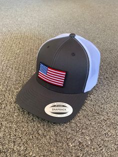 "This is a NEW United States of America Flag Embroidered Patch applied by hand to a high quality Yupoong or Richardson brand snapBack trucker hat Yupoong Classic SnapBacks are 65% Polyester/35% Cotton Structured 3 1/2\" mid-profile six-panel Permacurv Visor adjustable 6 7/8\" to 7 1/2\" Richardson Hats are 60% cotton/40% polyester Structured 3 1/2\" mid-profile six-panel Pre-curved Visor adjustable snapback closure 6 3/4\" -7 5/8\" Every Hat Design we offer is Created and Individually HANDCRAFTE Country Style Snapback Hat With Curved Brim, Flat Bill Hats Made In Usa For Outdoor, Outdoor Flat Bill Hats Made In Usa, Outdoor Cap Made In Usa, Adjustable Made In Usa Baseball Cap, Country Style Adjustable Snapback Baseball Cap, Adjustable Made-in-usa Baseball Cap, Curved Brim Baseball Cap Made In Usa For Outdoor, Adjustable Snapback Hat Made In Usa