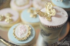 cupcakes decorated with gold and blue frosting