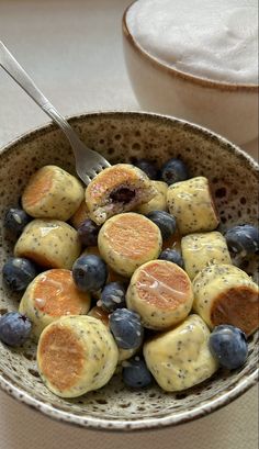 a bowl filled with blueberries and orange slices