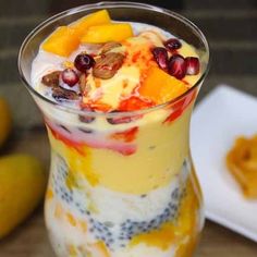 a dessert in a glass with fruit on top