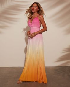 Where sunset hues meets effortless style, the Cora Ombre Maxi Dress was designed. Crafted from a pleated lightweight fabric, it flows gracefully with every step. The crisscross back straps add a touch of allure, perfect for warm evenings and beachside escapes. Embrace relaxed sophistication with this timeless piece that effortlessly transitions from day to night. V neckline Pleated lightweight fabric Adjustable crisscross back straps Hidden back zipper closure Lined 100% polyester Runs Large Summer Evening Dresses With Cross Back, Summer Evening Dress With Cross Back, Summer Party Maxi Dress With Cross Back, Chic Maxi Dress With Crisscross Straps For Summer, Chic Summer Maxi Dress With Crisscross Straps, Summer Evening Strappy Maxi Dress, Pink Beach Dress With Crisscross Straps, Strappy Maxi Dress For Summer Evenings, Chic Flowy Dress With Crisscross Straps