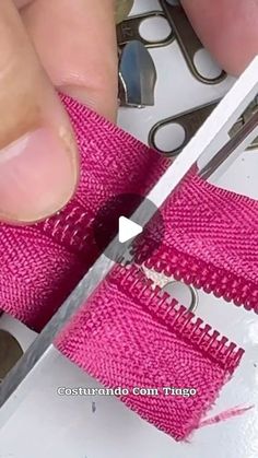 someone cutting fabric with a pair of scissors