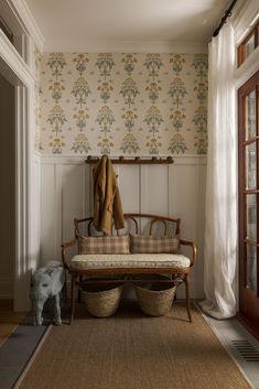 a wooden bench sitting in front of a window next to a wall with flowers on it