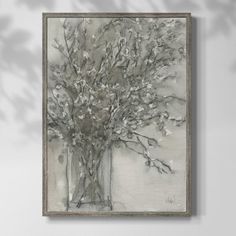 a painting hanging on the wall next to a vase with flowers in it and leaves