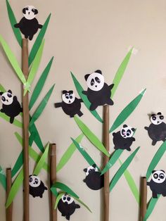 pandas on bamboo sticks are cut out to look like they are climbing up the tree