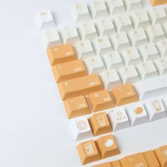 an orange and white computer keyboard sitting on top of a table