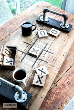 a wooden board with letters and numbers on it, next to a cup of coffee