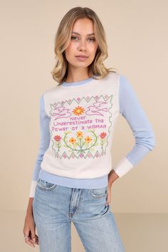 Empowered and adorable, the Stoned Immaculate Feminist White and Blue Cross Stitch Embroidered Sweater is ready to be your go-to girl power look! Ultra soft, luxuriously lightweight wool-blend knit shapes this vintage-inspired sweater that has a color block design with a relaxed-fit bodice, a crew neckline, and long sleeves. Multicolored cross stitch embroidery decorates the front, depicting two birds, a sun, and flowers, with the words ""Never underestimate the power of a woman"" at the center. Fall Sweater With Embroidered Text, Fitted Crew Neck Sweater With Floral Embroidery, Fitted Embroidered Crew Neck Sweater, Blue Cross Stitch, Sun And Flowers, Color Block Design, Blue Cross, Two Birds, Never Underestimate