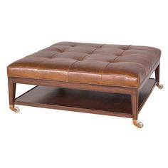 a brown leather ottoman sitting on top of a wooden shelf