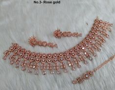 *rose gold , silver CZ necklace Set with earrings and tikka shown in the pic. *Adjustable length *Handmade item *No.1 *Color- rose gold *Necklace width- 0.9 inches *Earrings length- 1.4 inches *Material- Copper *Gem stone- Cubic zirconia *No.2 *Color- silver pink *Necklace width- 0.9 inches *Earrings length- 1.4 inches *Material- Copper *Gem stone- Cubic zirconia Gold Bridesmaid Jewelry, Indian Choker Necklace, Necklace Set Indian, Gold Bridesmaids, Nose Rings Hoop, Bollywood Jewelry, Choker Necklace Set, Cz Necklace, Gold Necklace Set