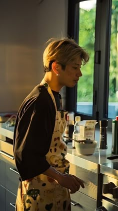 a woman standing in front of a counter preparing food