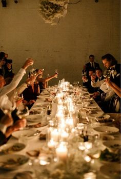 a group of people sitting around a long table