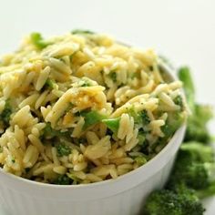 a white bowl filled with pasta and broccoli