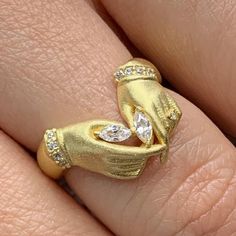 a woman's gold ring with diamonds on it