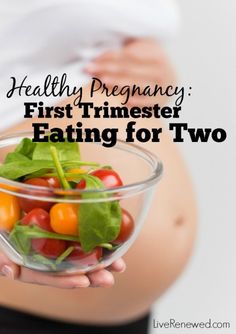 a pregnant woman holding a glass bowl filled with tomatoes and lettuce