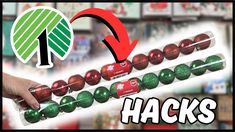 a hand is holding some christmas balls in front of a store shelf with the words hacks on it