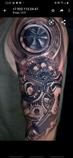 a man's arm with a clock and gears tattoo on it